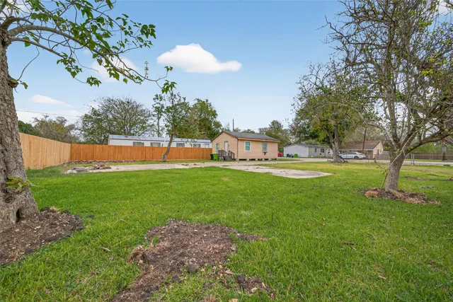 a view of yard with swimming pool and green space