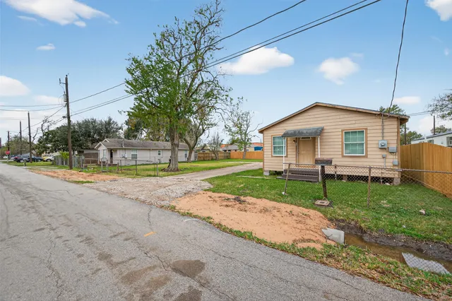 a view of a house with a patio and a yard