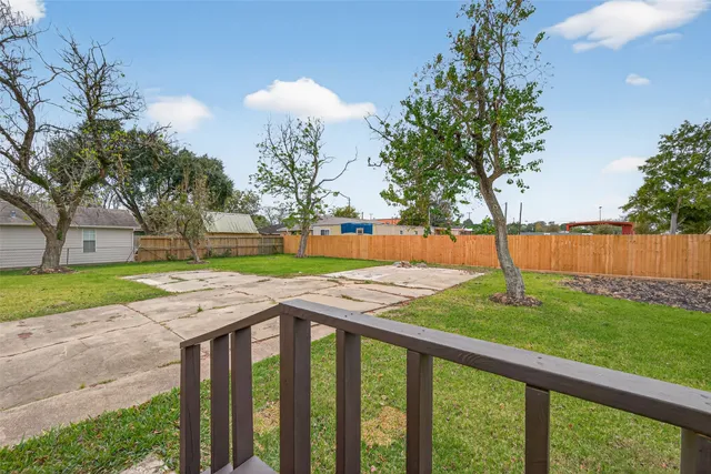 a view of a yard with large trees