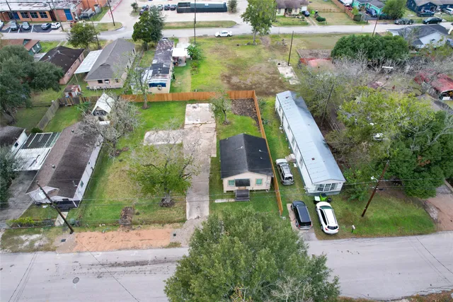 an aerial view of residential houses with outdoor space and street view