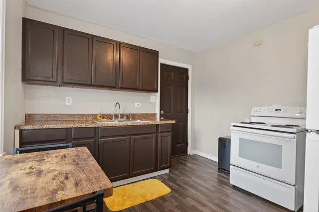 a kitchen with wooden cabinets and a sink