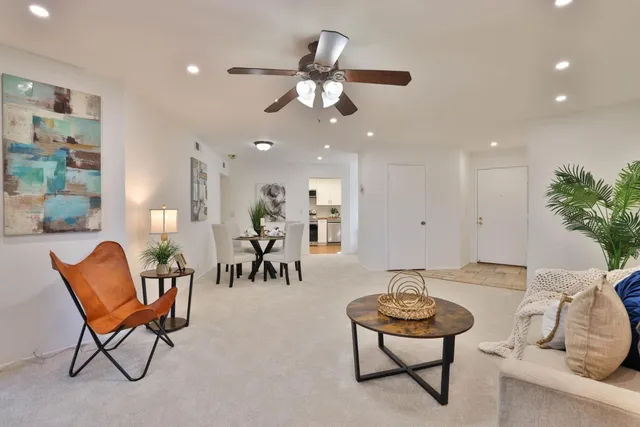 a living room with furniture and a chandelier