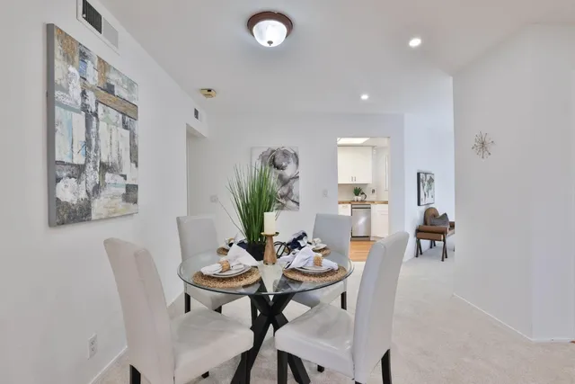 a view of a dining room with furniture and a potted plant