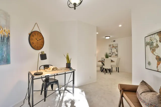 a view of a dining room with furniture and chandelier