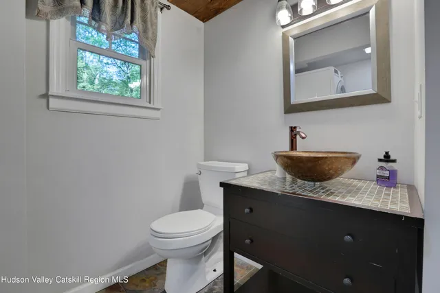 a bathroom with a toilet sink and mirror