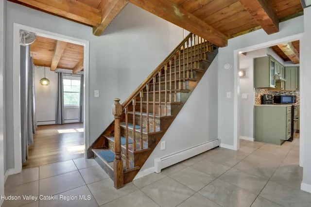 a view of entryway and hall with wooden floor