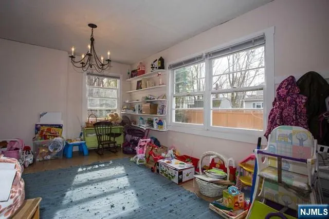 a bedroom with furniture toys and a window