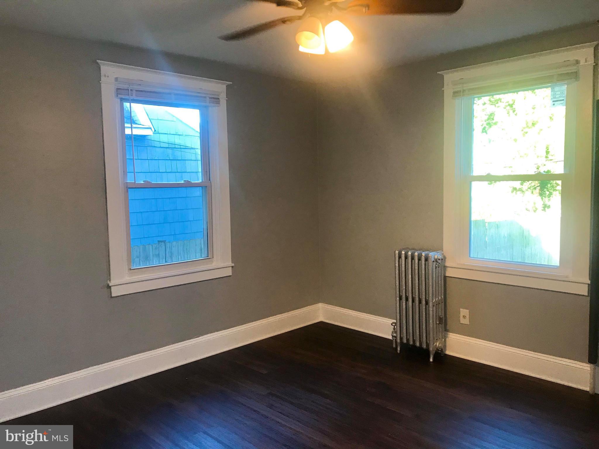 12 Leeway Dundalk, MD 21222 - Photo 11 of 24 a view of empty room with wooden floor and fan