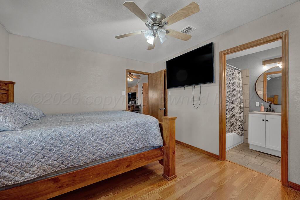 504 East 5th Street Sunray, TX 79086 - Photo 12 of 22 a bedroom with a bed and a flat screen tv