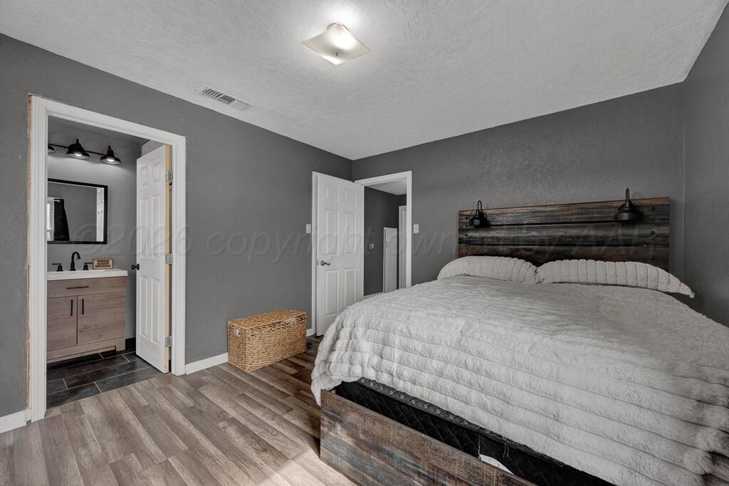 504 East 5th Street Sunray, TX 79086 - Photo 15 of 22 a bedroom with a bed and a view of bedroom