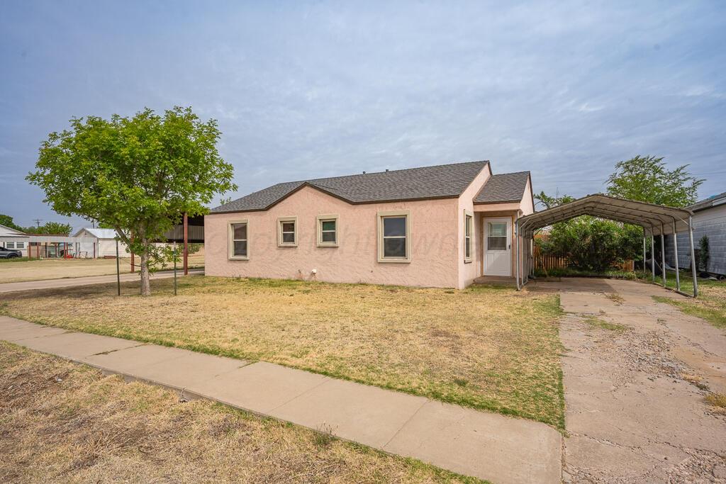 504 East 5th Street Sunray, TX 79086 - Photo 2 of 22 a view of a house with a backyard and a garage