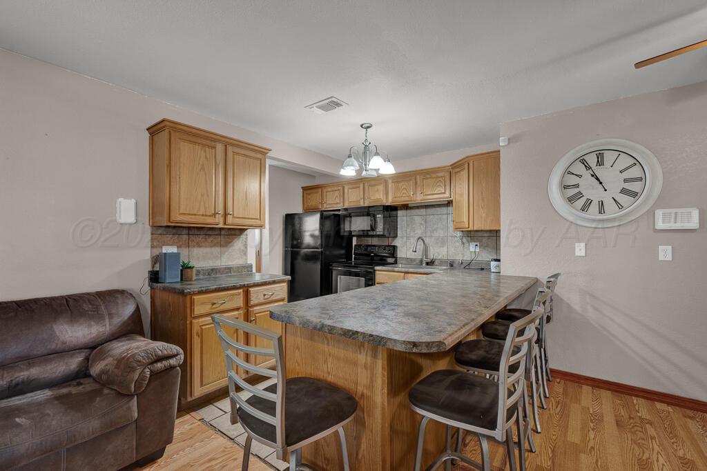504 East 5th Street Sunray, TX 79086 - Photo 7 of 22 a view of a kitchen with granite countertop a table and chairs in it