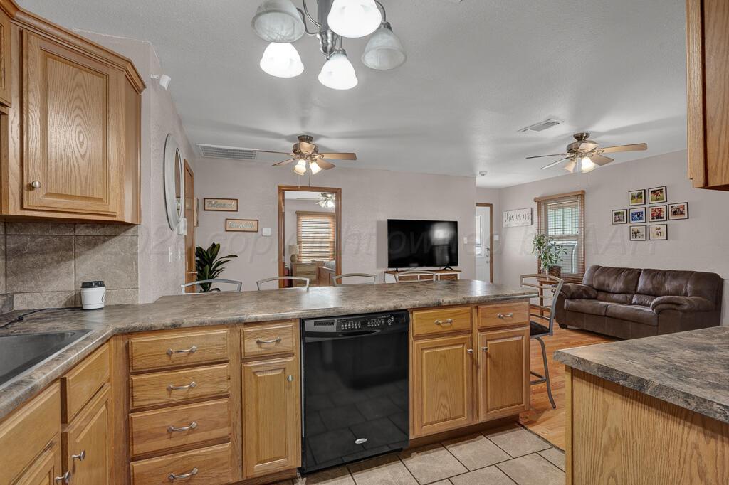 504 East 5th Street Sunray, TX 79086 - Photo 9 of 22 a kitchen with a sink stove and cabinets