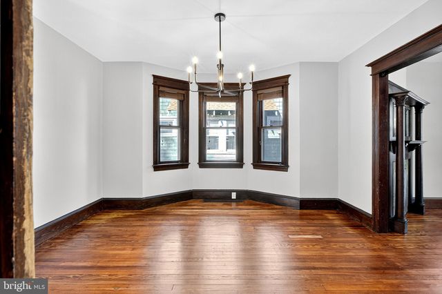 a view of a hallway with closet and mirror