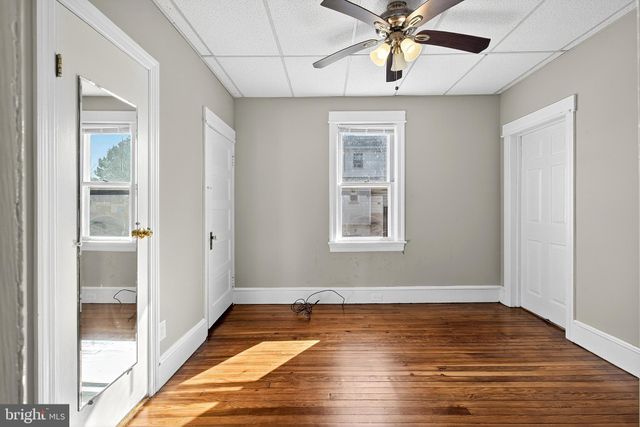 a kitchen with a refrigerator a sink and dishwasher with wooden floor