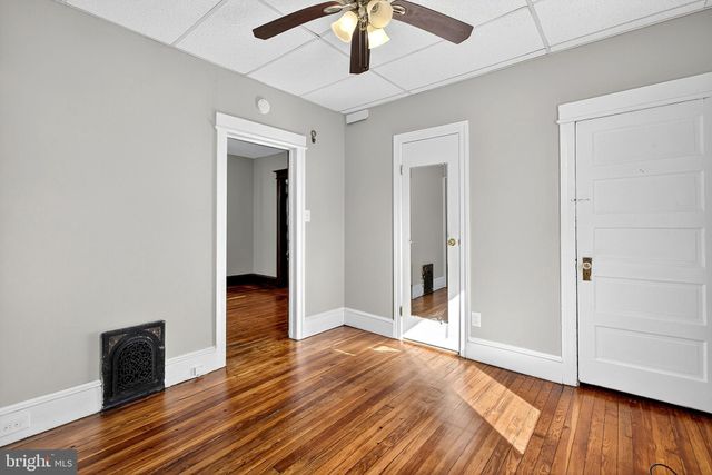 a kitchen with cabinets and wooden floor