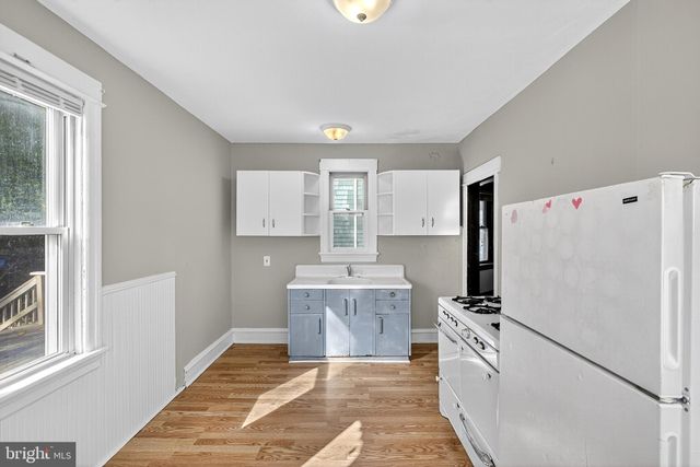 a view of a livingroom with a window and a ceiling fan