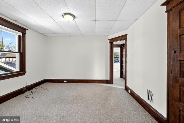 a view of a swimming pool with a lawn chairs and trees