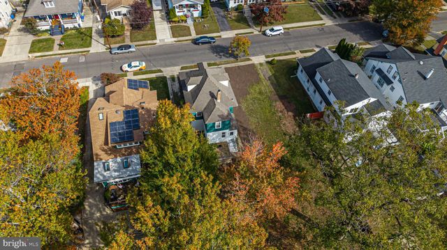 a front view of a house with a yard and patio