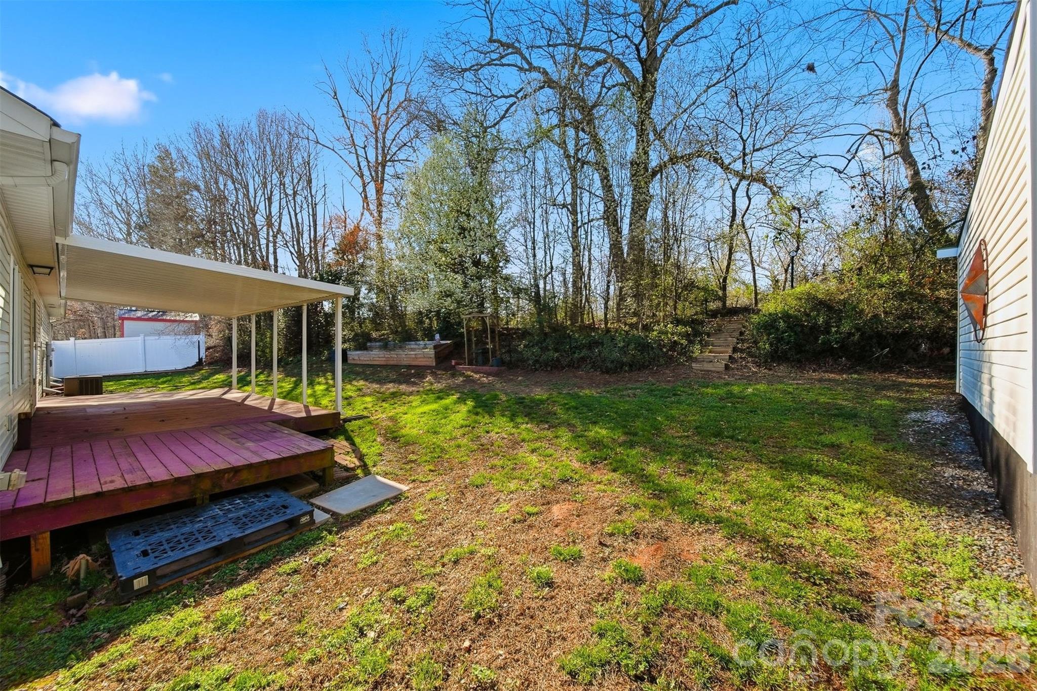 4771 Petra Mill Road Granite Falls, NC 28630 - Photo 7 of 46 a view of a yard with plants and trees