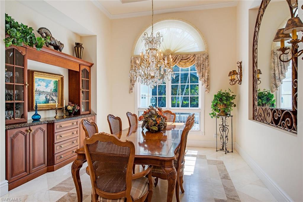 309 Little Harbour Lane Naples, FL 34102 - Photo 11 of 30 a view of a dining room with furniture and a large window