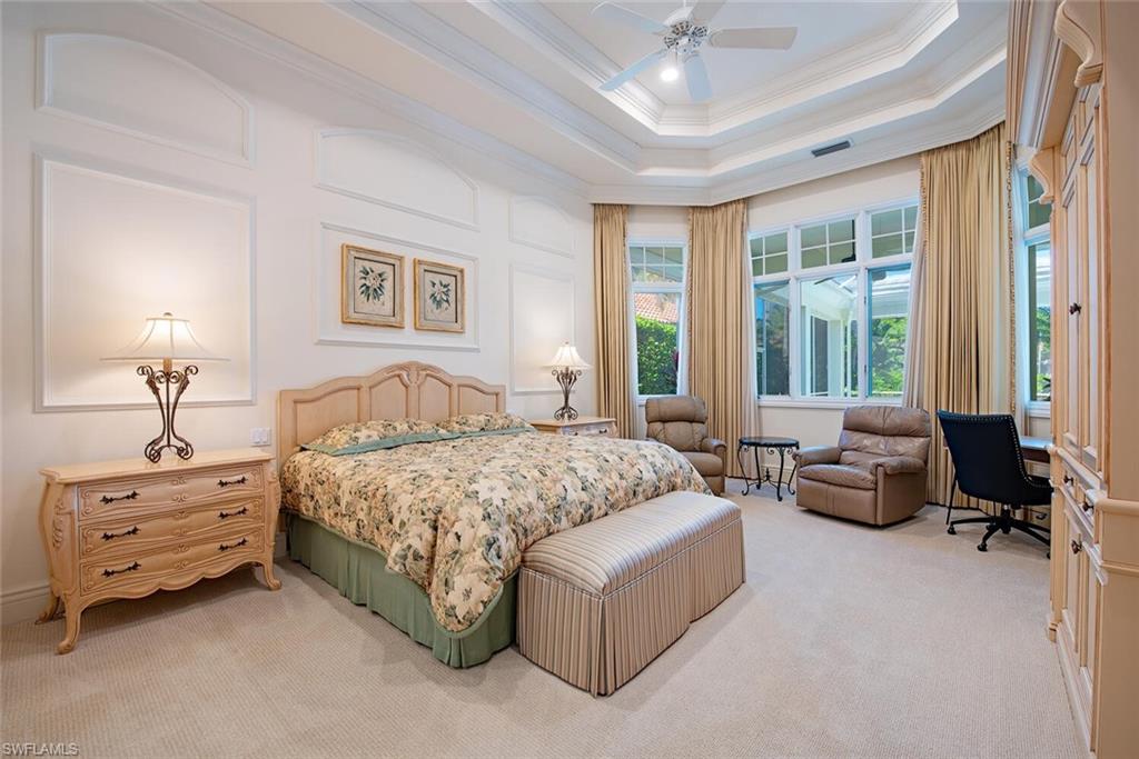 309 Little Harbour Lane Naples, FL 34102 - Photo 17 of 30 a spacious bedroom with a bed and a couch