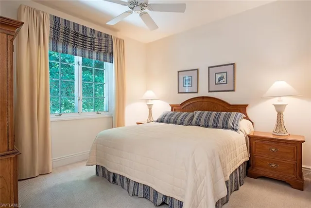 a bedroom with a bed and a night stand