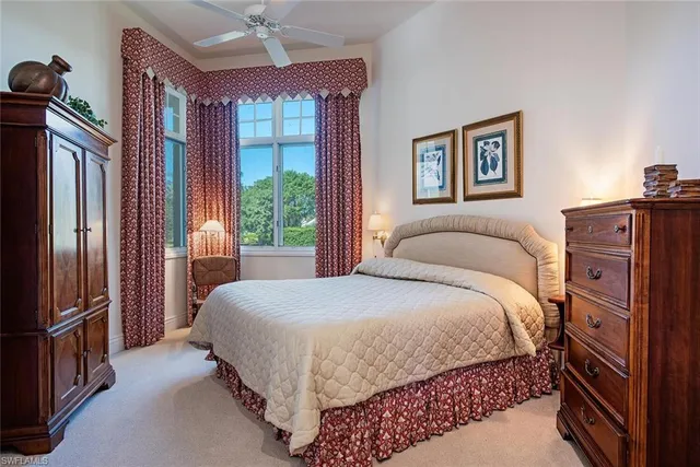 a bedroom with a bed dresser and a window