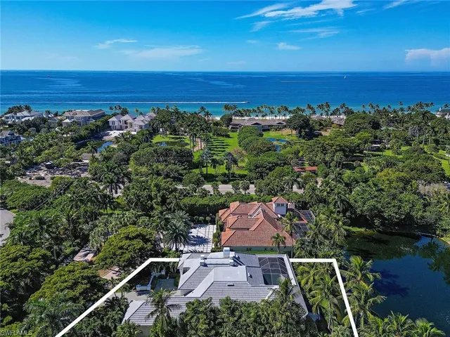 an aerial view of a house with a lake view