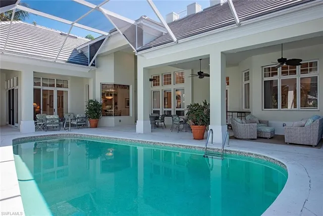 a swimming pool with outdoor seating