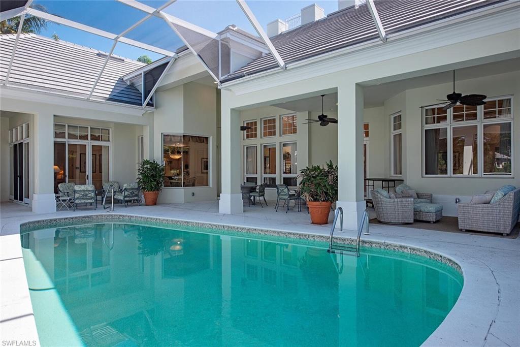 309 Little Harbour Lane Naples, FL 34102 - Photo 4 of 30 a swimming pool with outdoor seating
