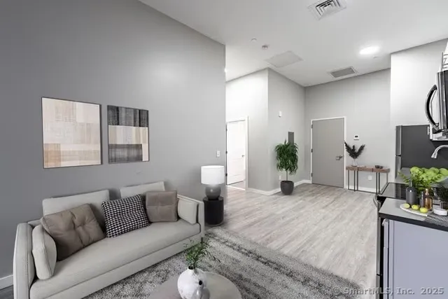 a living room with furniture and wooden floor