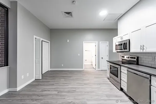 a view of a kitchen with electric appliances