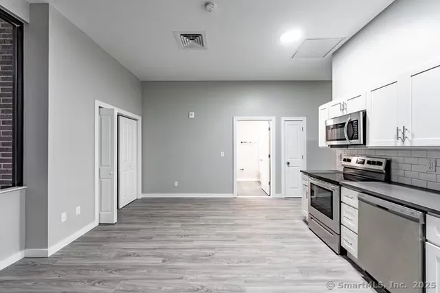 a view of a kitchen with electric appliances