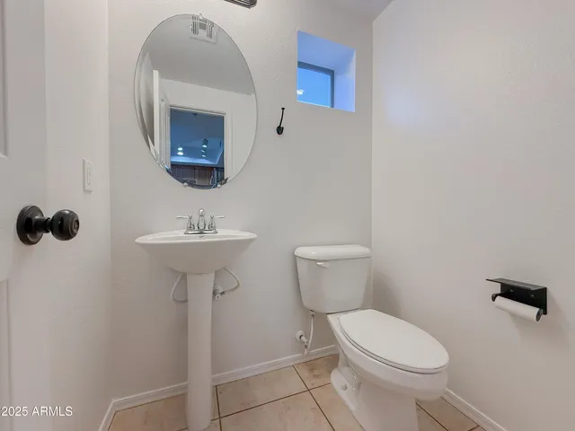 an empty room with ceiling fan and window