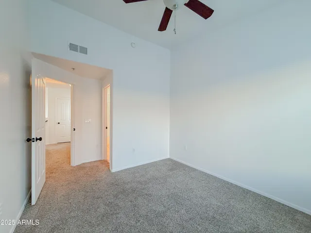 a bathroom with a granite countertop bathtub shower sink vanity and toilet