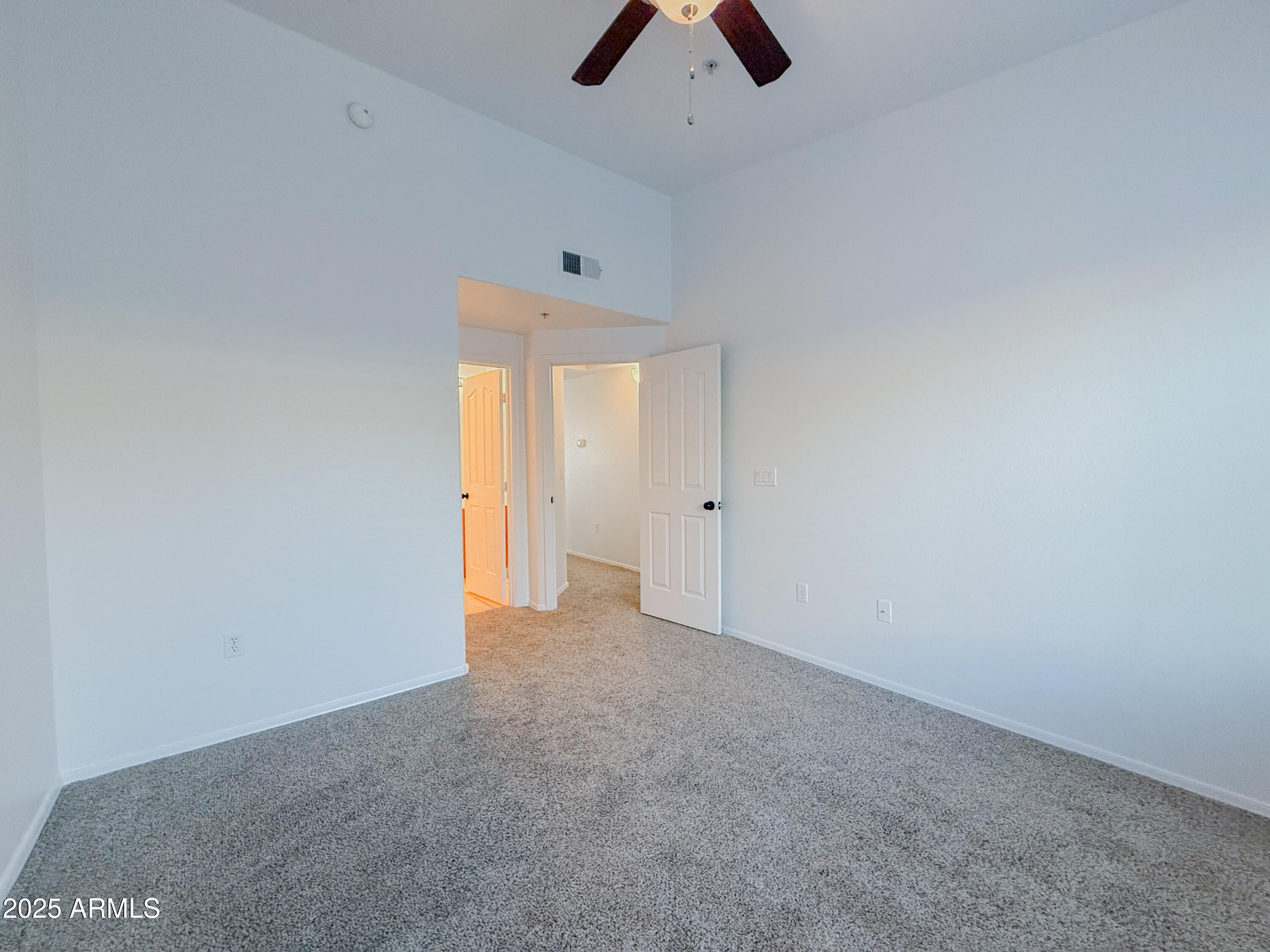 2150 West Alameda Road, Unit 1390 Phoenix, AZ 85085 - Photo 19 of 28 an empty room with chandelier fan