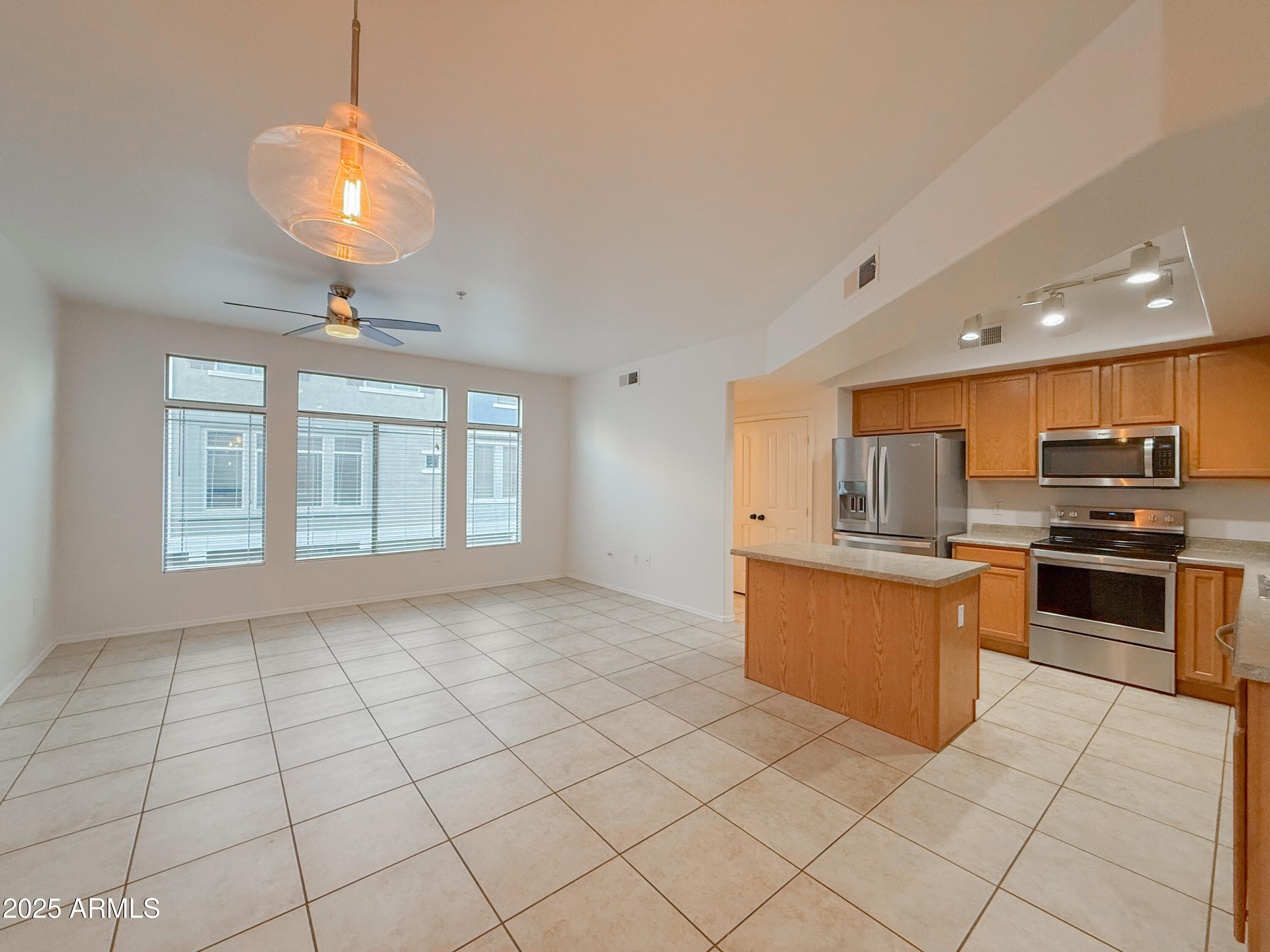 2150 West Alameda Road, Unit 1390 Phoenix, AZ 85085 - Photo 4 of 28 a kitchen with stainless steel appliances granite countertop a refrigerator and a stove top oven