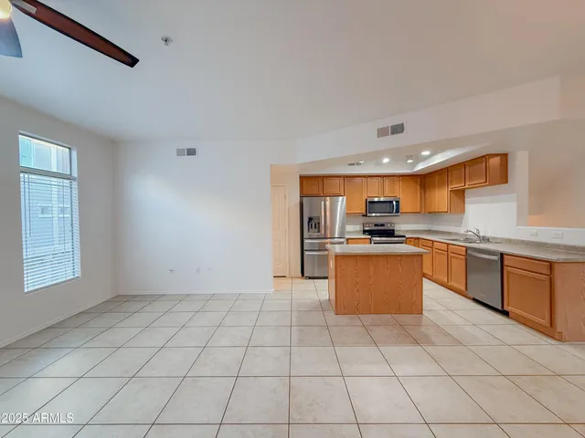 a kitchen with stainless steel appliances a refrigerator sink and cabinets