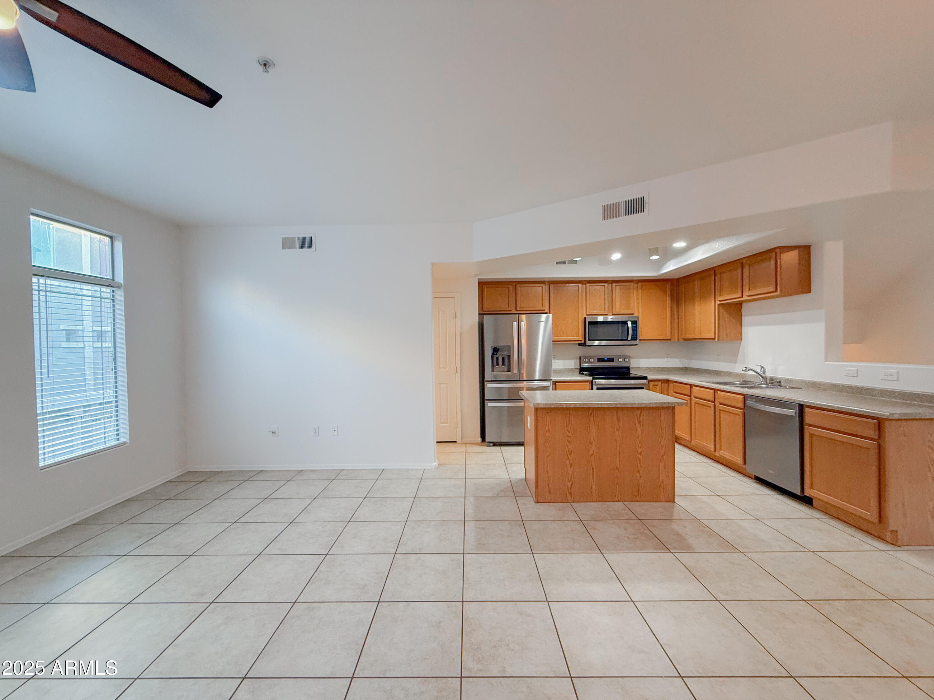 2150 West Alameda Road, Unit 1390 Phoenix, AZ 85085 - Photo 5 of 28 a kitchen with stainless steel appliances granite countertop a stove a sink and a refrigerator
