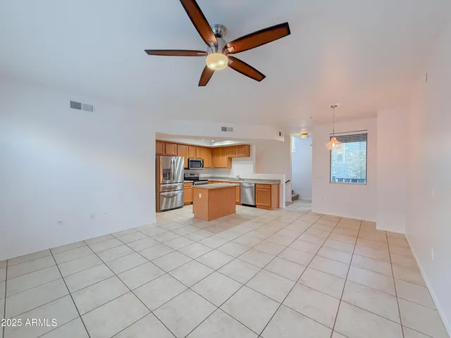 a large kitchen with stainless steel appliances granite countertop a sink and cabinets