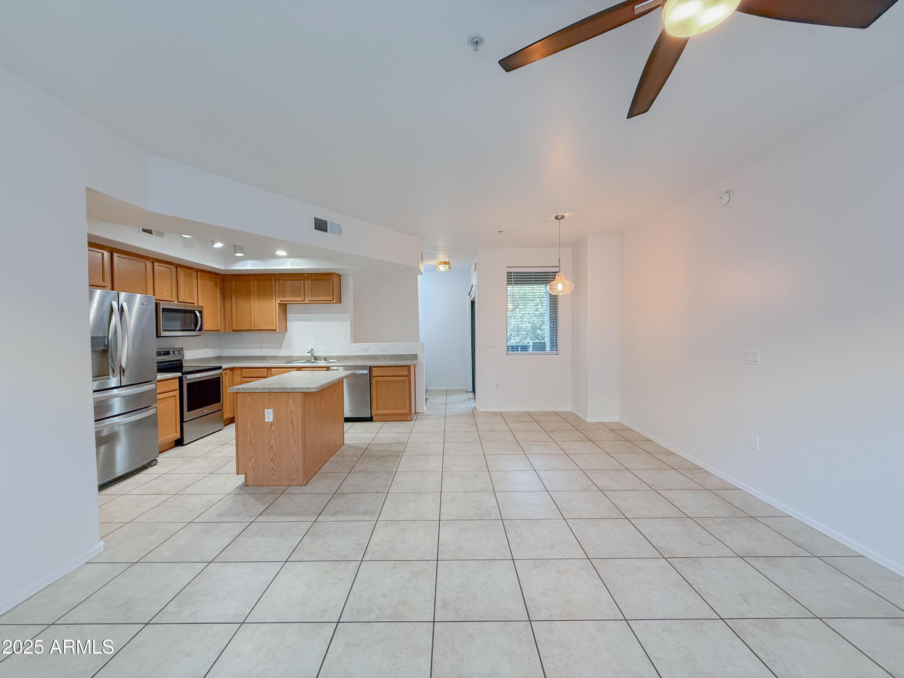 2150 West Alameda Road, Unit 1390 Phoenix, AZ 85085 - Photo 7 of 28 a kitchen with stainless steel appliances a refrigerator sink and cabinets