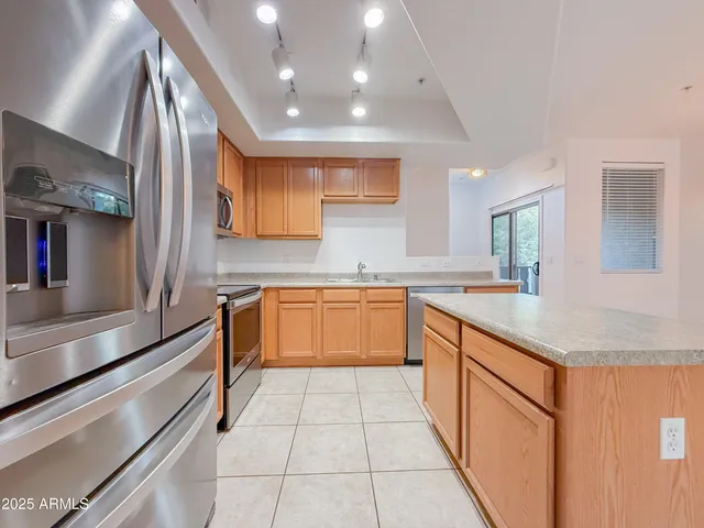 a kitchen with stainless steel appliances granite countertop a stove microwave and refrigerator