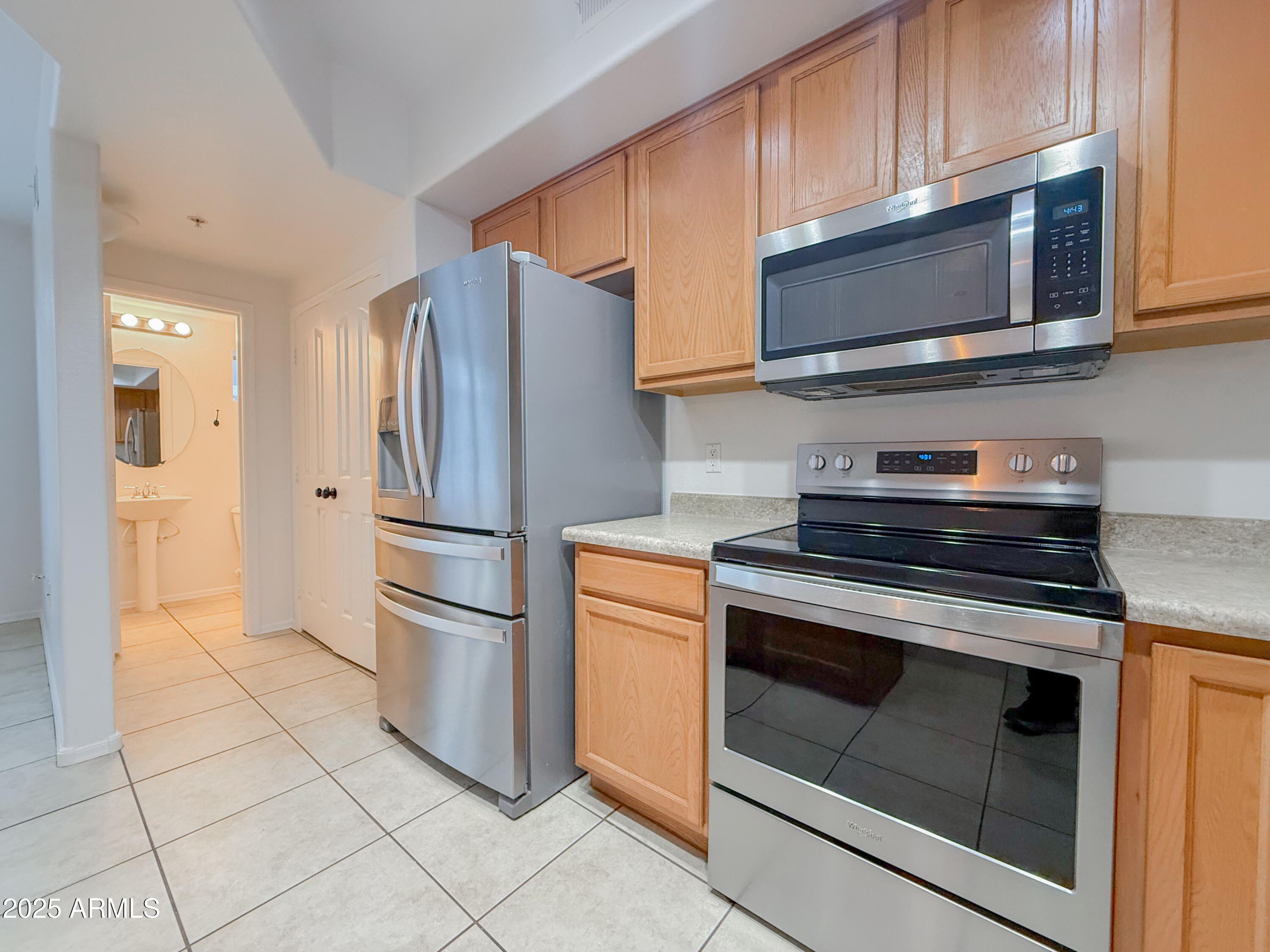 2150 West Alameda Road, Unit 1390 Phoenix, AZ 85085 - Photo 10 of 28 a kitchen with stainless steel appliances granite countertop a stove microwave and refrigerator