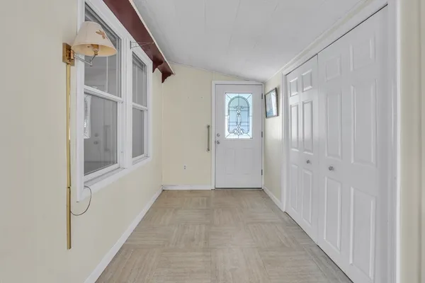 a view of an entryway with wooden floor