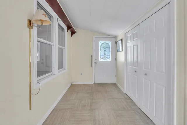 a view of an entryway with wooden floor