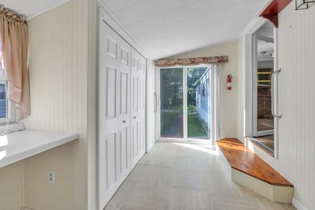 a kitchen with white cabinets and appliances