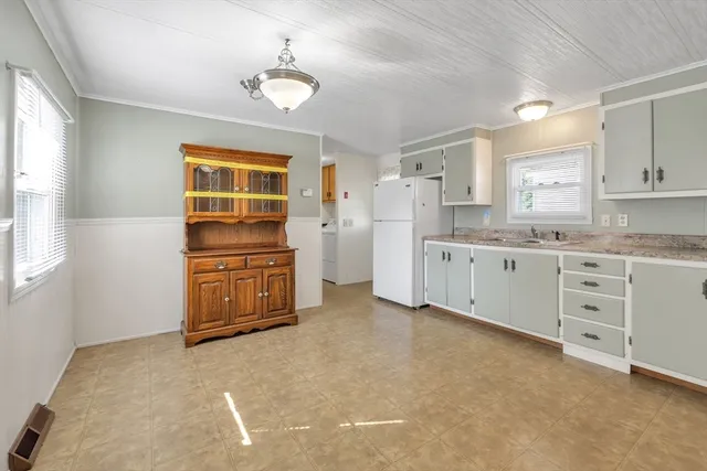 a kitchen with granite countertop cabinets and white appliances