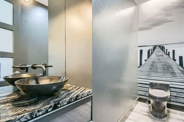 a view of a hallway with wooden floor and a living room