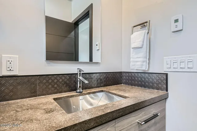 a view of swimming pool with a table and chairs under an umbrella